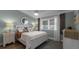 Cozy bedroom with white furniture and large window at 450 Bouchelle Dr # 301, New Smyrna Beach, FL 32169