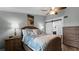 Comfortable bedroom with ceiling fan, sliding barn door to bathroom, and dresser at 450 Bouchelle Dr # 301, New Smyrna Beach, FL 32169