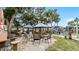 Relaxing community fire pit area with shaded seating at 450 Bouchelle Dr # 301, New Smyrna Beach, FL 32169