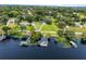 Aerial view of lakefront home and boathouse at 512 E Lakeshore Dr, Clermont, FL 34711