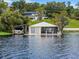 Lakefront boathouse with boat lift and screened porch at 512 E Lakeshore Dr, Clermont, FL 34711