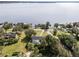 Aerial view of lakefront property with house and pool; expansive lake view at 512 E Lakeshore Dr, Clermont, FL 34711