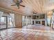Bright great room with a brick fireplace and wood ceilings at 6118 Dora Dr, Mount Dora, FL 32757