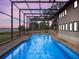Inviting pool and spa area with a screened enclosure and lake view at 6118 Dora Dr, Mount Dora, FL 32757