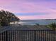 Stunning sunset over a tranquil lake, as seen from a covered balcony at 6118 Dora Dr, Mount Dora, FL 32757