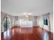 Spacious living room featuring hardwood floors, fireplace, and access to a balcony at 6118 Dora Dr, Mount Dora, FL 32757