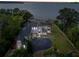 Stunning waterfront estate showcasing a large home, private dock, and lush landscaping at 6118 Dora Dr, Mount Dora, FL 32757