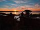 Private boat dock with covered area at sunset at 6118 Dora Dr, Mount Dora, FL 32757