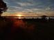 Sunset view over calm lake from grassy backyard at 6118 Dora Dr, Mount Dora, FL 32757