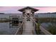 Private boat dock with covered lift and beautiful sunset views at 6118 Dora Dr, Mount Dora, FL 32757