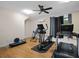Bright home gym with hardwood floors, treadmill, elliptical, and weight bench at 6118 Dora Dr, Mount Dora, FL 32757