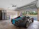 Spacious garage with classic car, ample storage, and high ceiling at 6118 Dora Dr, Mount Dora, FL 32757