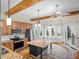 Bright kitchen featuring an island, stainless steel appliances, and wood beam accents at 6118 Dora Dr, Mount Dora, FL 32757