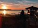 Private boat dock with covered area at sunset at 6118 Dora Dr, Mount Dora, FL 32757