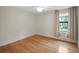 Hardwood floor bedroom with window and curtains at 6118 Dora Dr, Mount Dora, FL 32757
