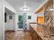 Laundry room with granite countertops, tile floor, and exterior access at 6118 Dora Dr, Mount Dora, FL 32757
