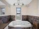 Relaxing bathroom with soaking tub and tile surround at 6118 Dora Dr, Mount Dora, FL 32757