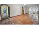 Open living area with terracotta floors and access to patio at 6118 Dora Dr, Mount Dora, FL 32757