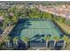 Aerial view of two tennis courts surrounded by palm trees at 7319 Oakmoss Loop, Davenport, FL 33837