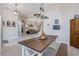 Farmhouse dining table with bench seating, view into living room at 7350 Spring Mountain Ln, Yalaha, FL 34797