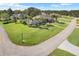 Aerial view of a house with pool and lush landscaping, showcasing its location in a desirable neighborhood at 7350 Spring Mountain Ln, Yalaha, FL 34797