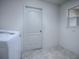 Laundry room with washer, dryer and door at 8288 Se 177Th Winterthur Loop, The Villages, FL 32162