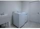 Laundry room with washer, dryer, and utility sink at 8288 Se 177Th Winterthur Loop, The Villages, FL 32162