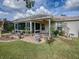 Single story home with covered patio, landscaped yard, and a screened enclosure at 8288 Se 177Th Winterthur Loop, The Villages, FL 32162