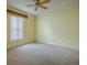 Spacious bedroom with ceiling fan and window at 8288 Se 177Th Winterthur Loop, The Villages, FL 32162