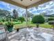 Spacious back patio with a view of the backyard and lush landscaping at 8288 Se 177Th Winterthur Loop, The Villages, FL 32162