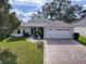 Single story home with attached two-car garage and landscaped yard at 8288 Se 177Th Winterthur Loop, The Villages, FL 32162