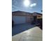 Front view of a tan house with a white garage door and driveway at 928 Nuthatch Ave, The Villages, FL 32163