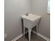 Laundry room with utility sink and vinyl flooring at 928 Nuthatch Ave, The Villages, FL 32163