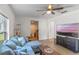 Spacious living room with sectional sofa, large TV, and ceiling fan at 1109 S Smith Ave, Lakeland, FL 33815