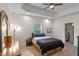 Main bedroom with a queen bed, dresser, and ceiling fan at 1109 S Smith Ave, Lakeland, FL 33815