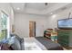 Main bedroom with a large bed, TV, and access to the bathroom at 1109 S Smith Ave, Lakeland, FL 33815