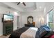 Main bedroom with a queen bed, dark green dresser, and large TV at 1109 S Smith Ave, Lakeland, FL 33815