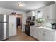 Modern kitchen with white cabinets, stainless steel appliances, and a view into the bathroom at 1109 S Smith Ave, Lakeland, FL 33815