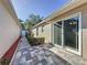 Backyard patio with multi-colored tile and access from sliding glass doors at 2084 Braxton St, Clermont, FL 34711