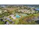 Aerial view of community pool, tennis courts, and surrounding landscape at 21732 King Henry Ave, Leesburg, FL 34748