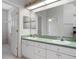 Double vanity bathroom with a large mirror and closet at 21732 King Henry Ave, Leesburg, FL 34748