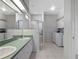 Bathroom with double vanity, shower, and laundry area at 21732 King Henry Ave, Leesburg, FL 34748