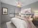 Spacious bedroom with a king-size bed, nightstands, and a ceiling fan at 21732 King Henry Ave, Leesburg, FL 34748
