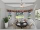 Bright dining area with a round table and four chairs, overlooking a scenic view at 21732 King Henry Ave, Leesburg, FL 34748
