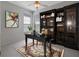 Home office with a dark wood desk, built-in shelving, and an area rug at 21732 King Henry Ave, Leesburg, FL 34748