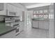 Well-equipped kitchen with white cabinets and green countertops at 21732 King Henry Ave, Leesburg, FL 34748