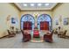 Community clubhouse lobby with comfortable seating and large arches at 21732 King Henry Ave, Leesburg, FL 34748