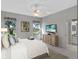 Main bedroom with king bed, ceiling fan, and views of backyard at 21732 King Henry Ave, Leesburg, FL 34748