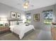 Main bedroom with king bed, ceiling fan, and views of backyard at 21732 King Henry Ave, Leesburg, FL 34748