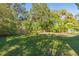 Spacious backyard with lush greenery and wooden fence at 2602 Cr 422, Lake Panasoffkee, FL 33538